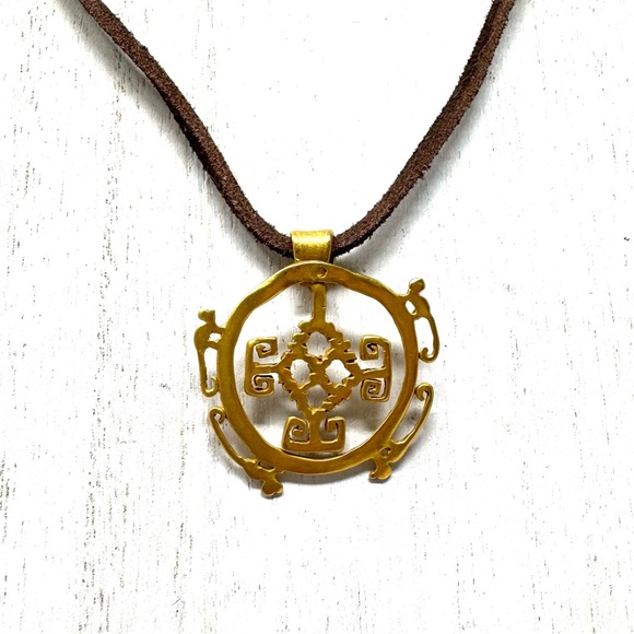 Mayan design gold tone pendant purchased in Costa Rica on brown suede c…